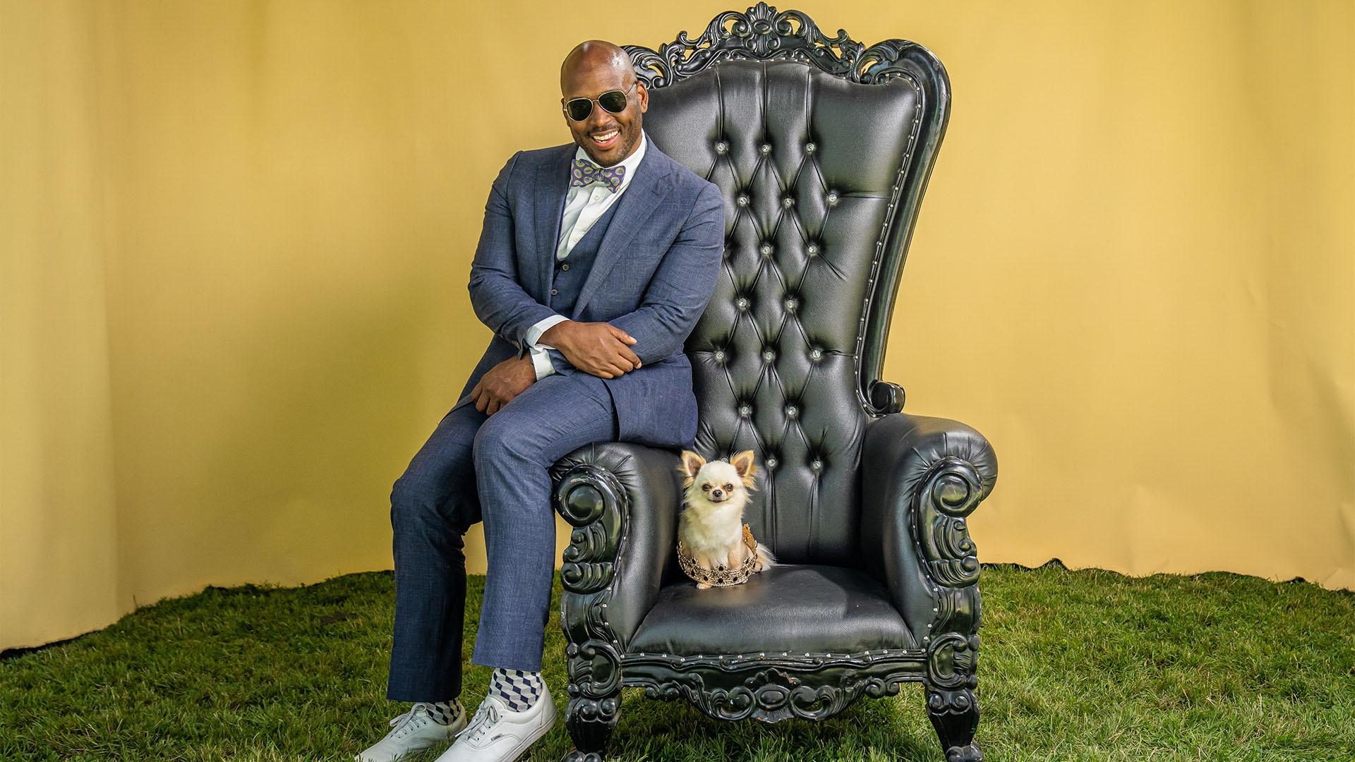 Shane sits on a throne with a purebred dog at the Westminster Kennel Club Dog Show.