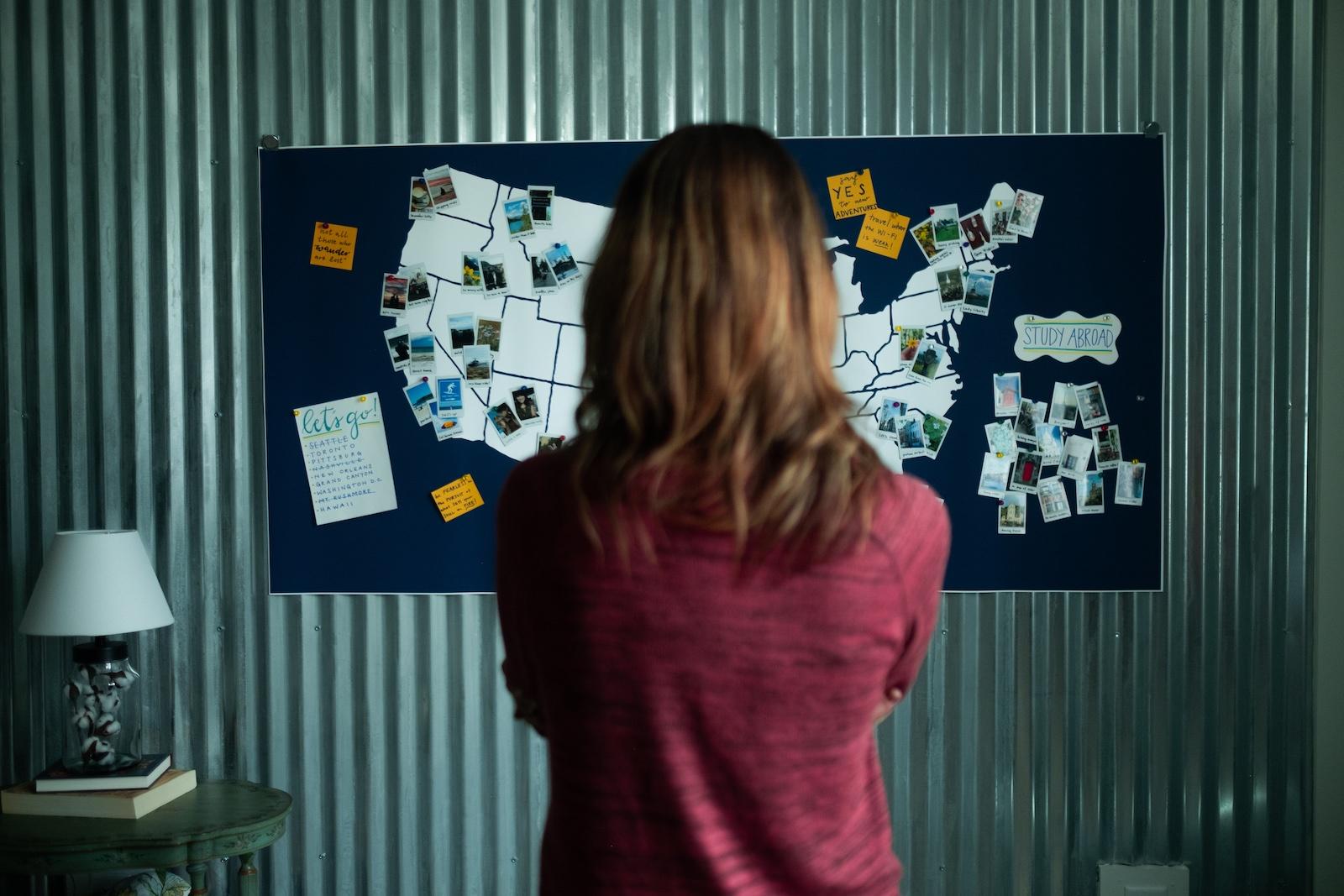 Woman stands before a map of the US